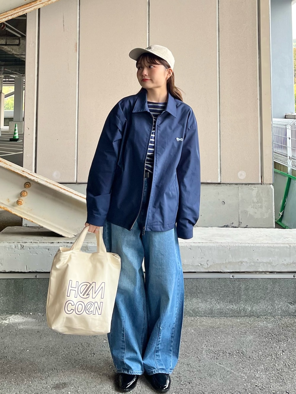 ブルー系のブルゾン、ブルー系のTシャツ/カットソー、ブルー系のデニムパンツを着用したレディースの春コーディネートの4枚目の写真