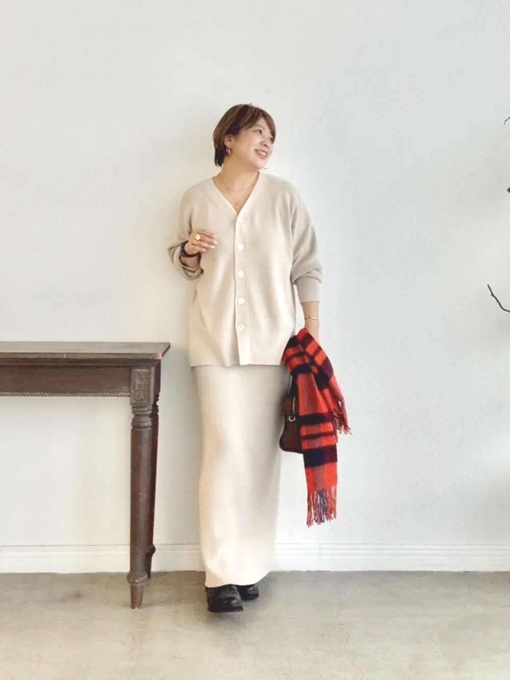 ホワイト系のニット/セーター、ホワイト系のスカートを着用したレディースの秋コーディネートの7枚目の写真