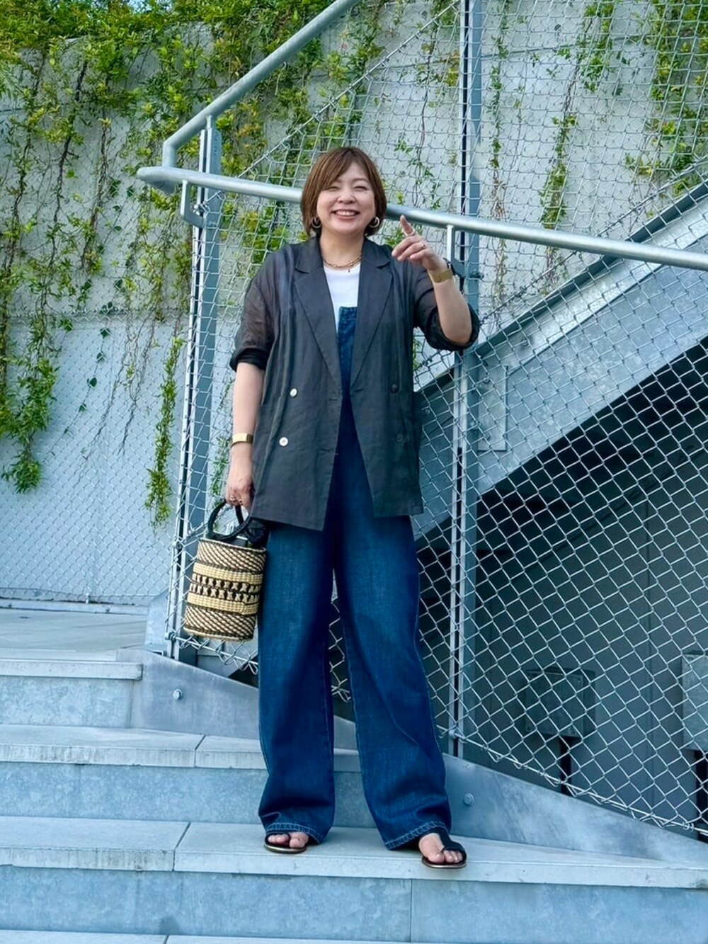 ブルー系のサロペット/オーバーオール、ブラック系のテーラードジャケットを着用したレディースの夏コーディネートの3枚目の写真