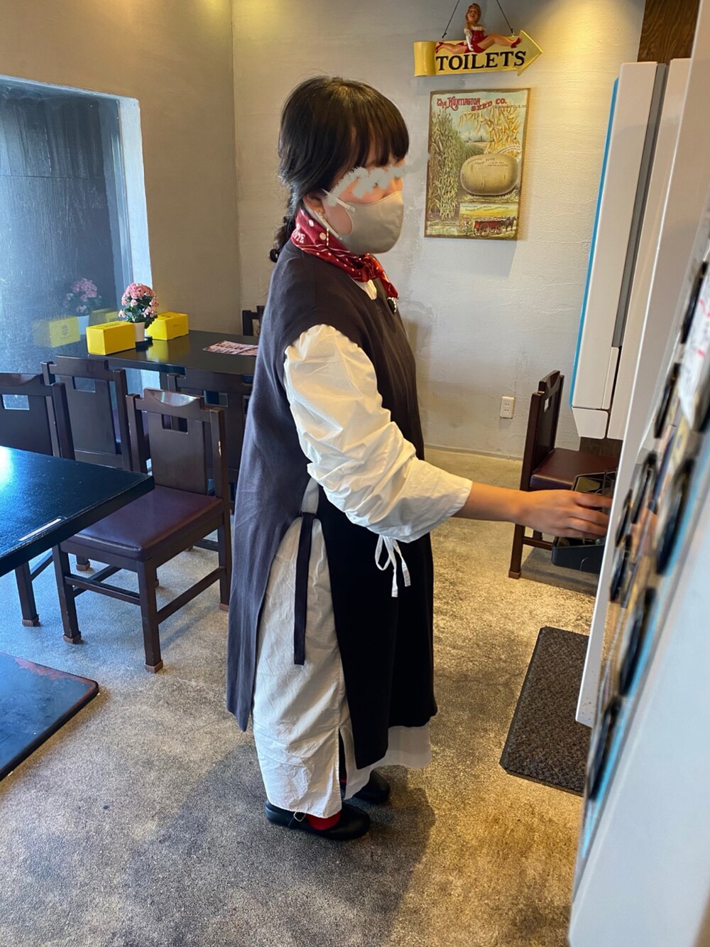 ホワイト系のワンピース、ブラック系のベスト、ブラウン系のかごバッグを着用したレディースの春コーディネートの2枚目の写真