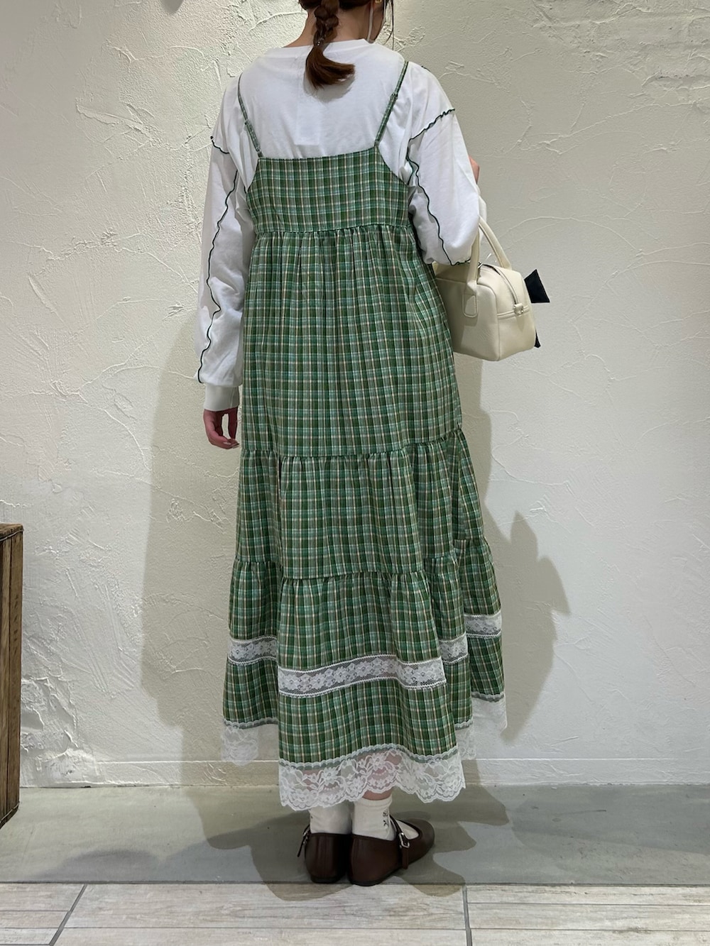 ホワイト系のTシャツ/カットソー、グリーン系のワンピース、ホワイト系のバッグを着用したレディースの春コーディネートの2枚目の写真