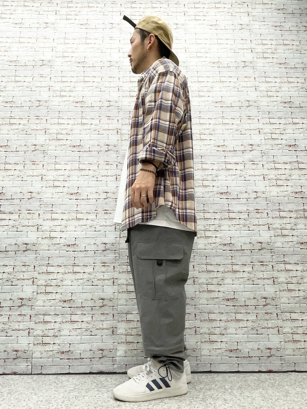 ブラウン系のシャツ/ブラウス、ホワイト系のTシャツ/カットソー、グリーン系のカーゴパンツを着用したメンズの秋コーディネートの2枚目の写真