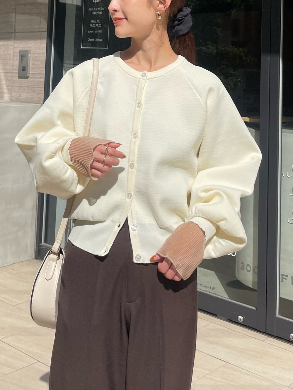 ホワイト系のカーディガン/ボレロ、ホワイト系のスニーカーを着用したレディースの秋コーディネートの2枚目の写真