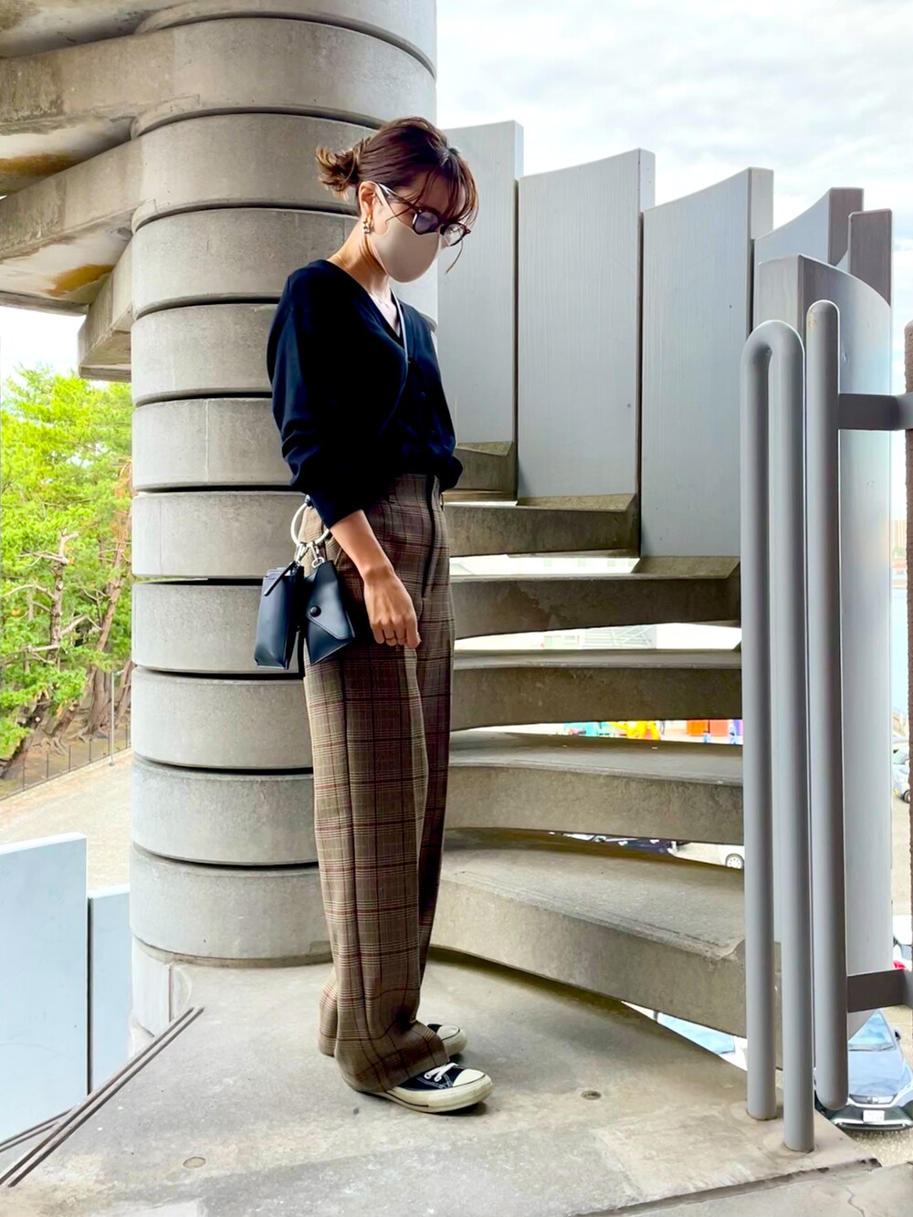 ブラック系のカーディガン/ボレロ、ブラック系のショルダーバッグ、ベージュ系のスラックスを着用したレディースの秋コーディネートの2枚目の写真