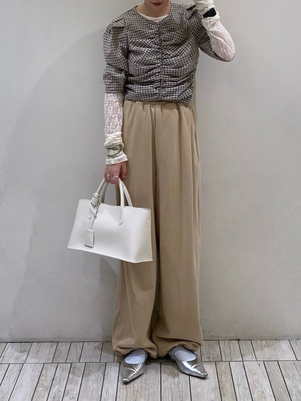ベージュ系のシャツ/ブラウス、ベージュ系のその他パンツ、ホワイト系のハンドバッグを着用したレディースの春コーディネートの2枚目の写真