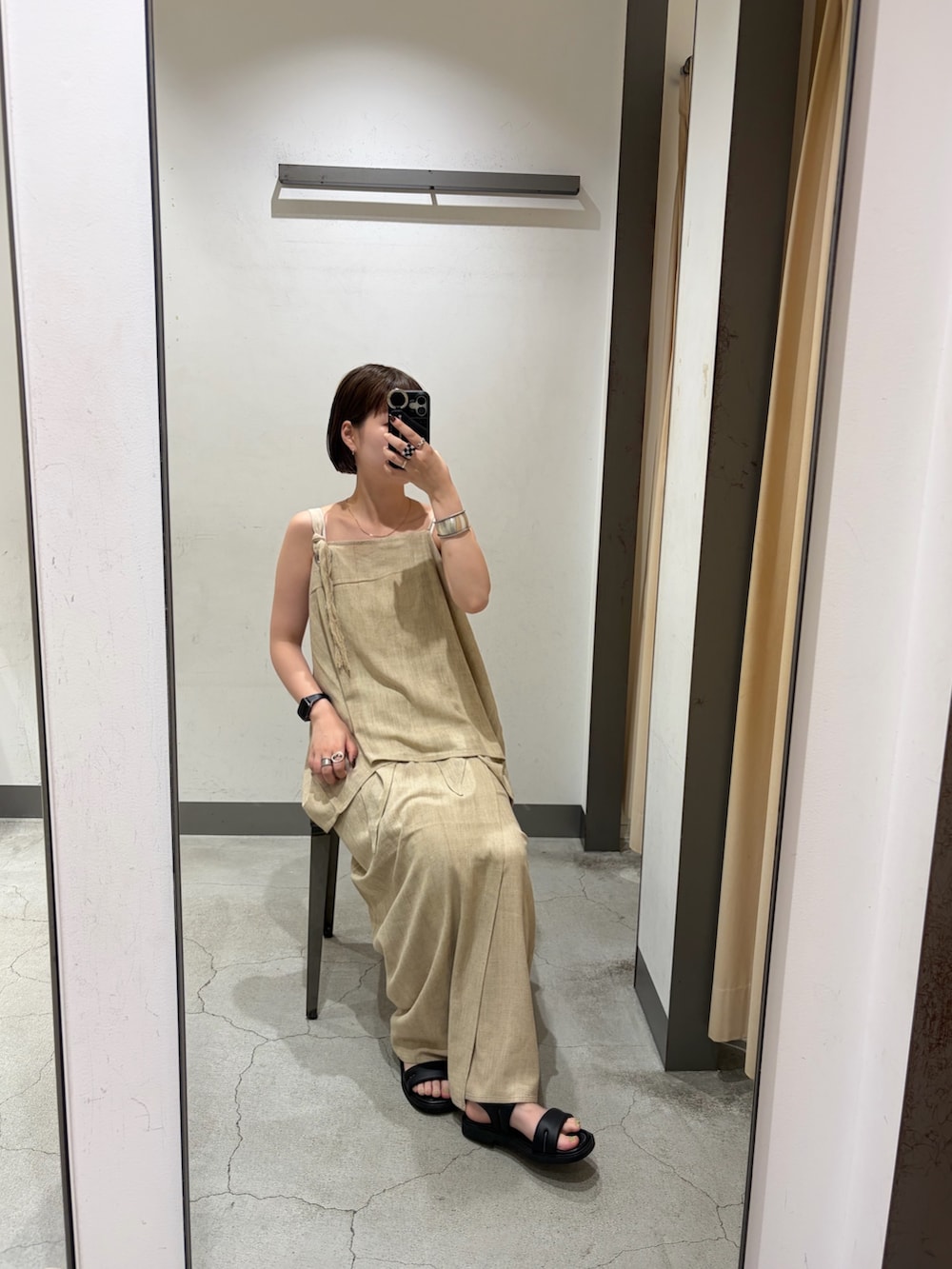 ブラック系のハンドバッグ、イエロー系のTシャツ/カットソー、ベージュ系のワンピースを着用したレディースの夏コーディネートの3枚目の写真