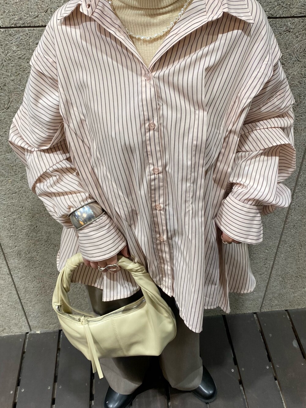 ピンク系のシャツ/ブラウス、ホワイト系のハンドバッグ、グレー系のその他パンツを着用したレディースの冬コーディネートの3枚目の写真