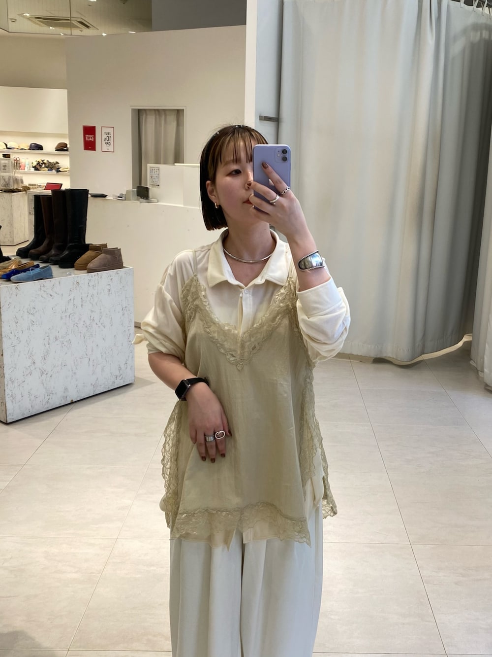 ベージュ系のキャミソール、ベージュ系のボストンバッグ、ホワイト系のシャツ/ブラウスを着用したレディースの冬コーディネートの3枚目の写真