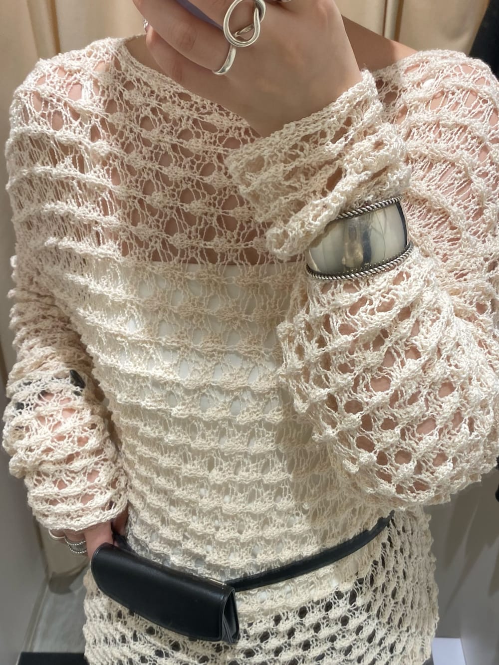 ホワイト系のニット/セーター、ブラウン系のその他パンツ、ブラック系のベルトを着用したレディースの春コーディネートの4枚目の写真