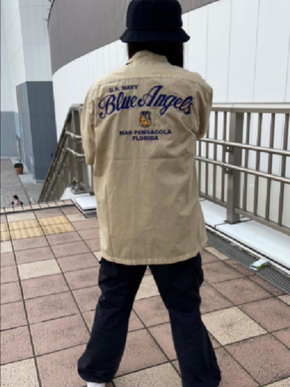 グリーン系のシャツ/ブラウス、ホワイト系のTシャツ/カットソー、ブラック系のハットを着用したレディースの夏コーディネートの3枚目の写真