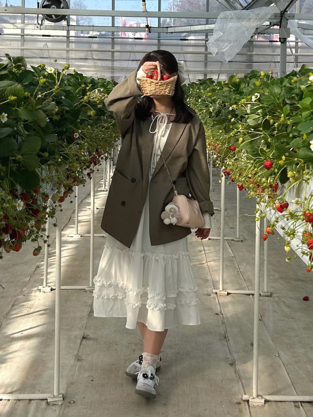 ホワイト系のTシャツ/カットソー、ベージュ系のテーラードジャケット、ホワイト系のスカートを着用したレディースの春コーディネートの2枚目の写真