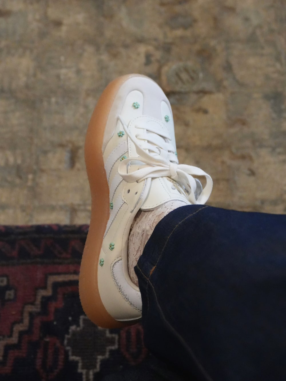 ブルー系のデニムパンツ、ホワイト系のTシャツ/カットソー、ベージュ系のかごバッグを着用したレディースの春コーディネートの4枚目の写真