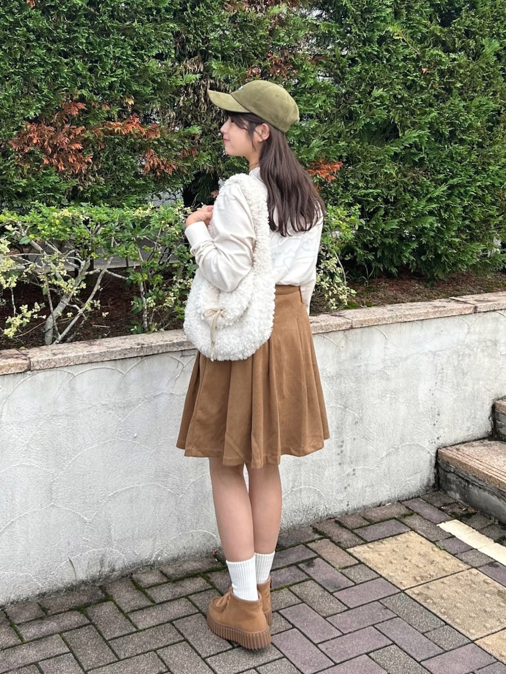 ベージュ系のモカシン/デッキシューズ、ベージュ系のTシャツ/カットソー、ベージュ系のスカートを着用したレディースの秋コーディネートの3枚目の写真