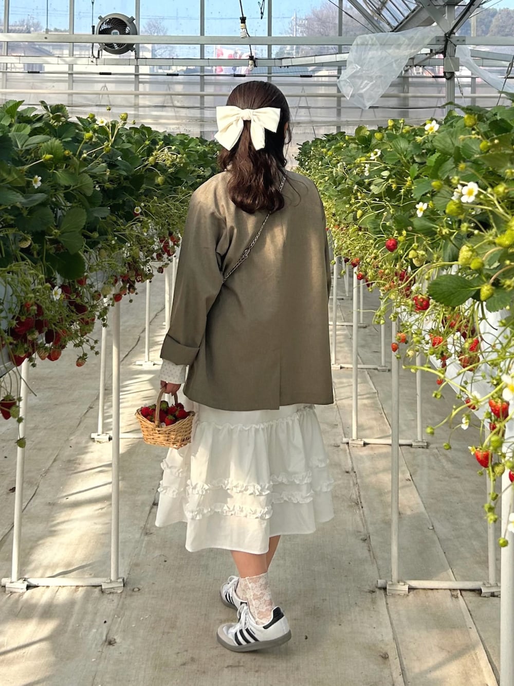 ホワイト系のTシャツ/カットソー、ベージュ系のテーラードジャケット、ホワイト系のスカートを着用したレディースの春コーディネートの3枚目の写真