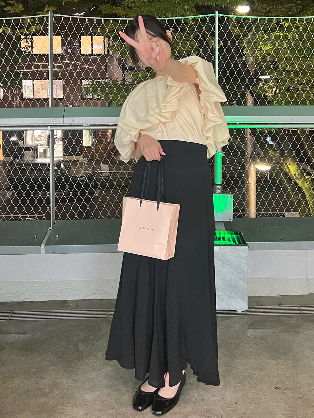 ブラック系のスカート、ブラック系のバレエシューズ、ベージュ系のシャツ/ブラウスを着用したレディースの秋コーディネートの2枚目の写真