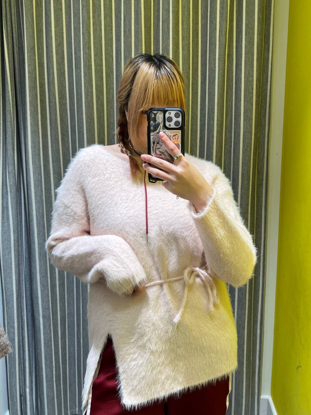 ピンク系のチュニック、レッド系のネックレスを着用したレディースの冬コーディネートの4枚目の写真