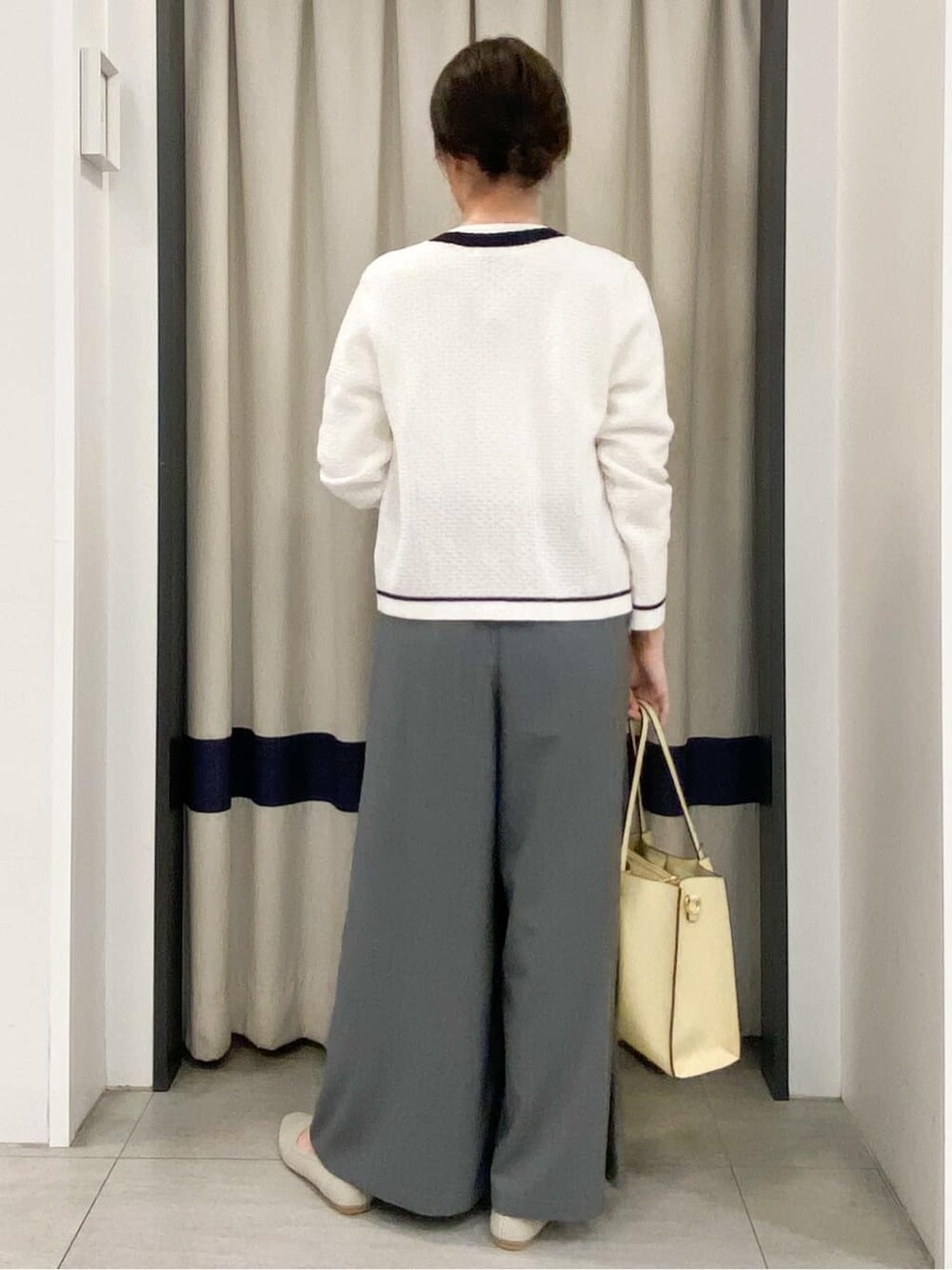 ホワイト系のカーディガン/ボレロ、ホワイト系のニット/セーター、グレー系のその他パンツを着用したレディースの春コーディネートの3枚目の写真
