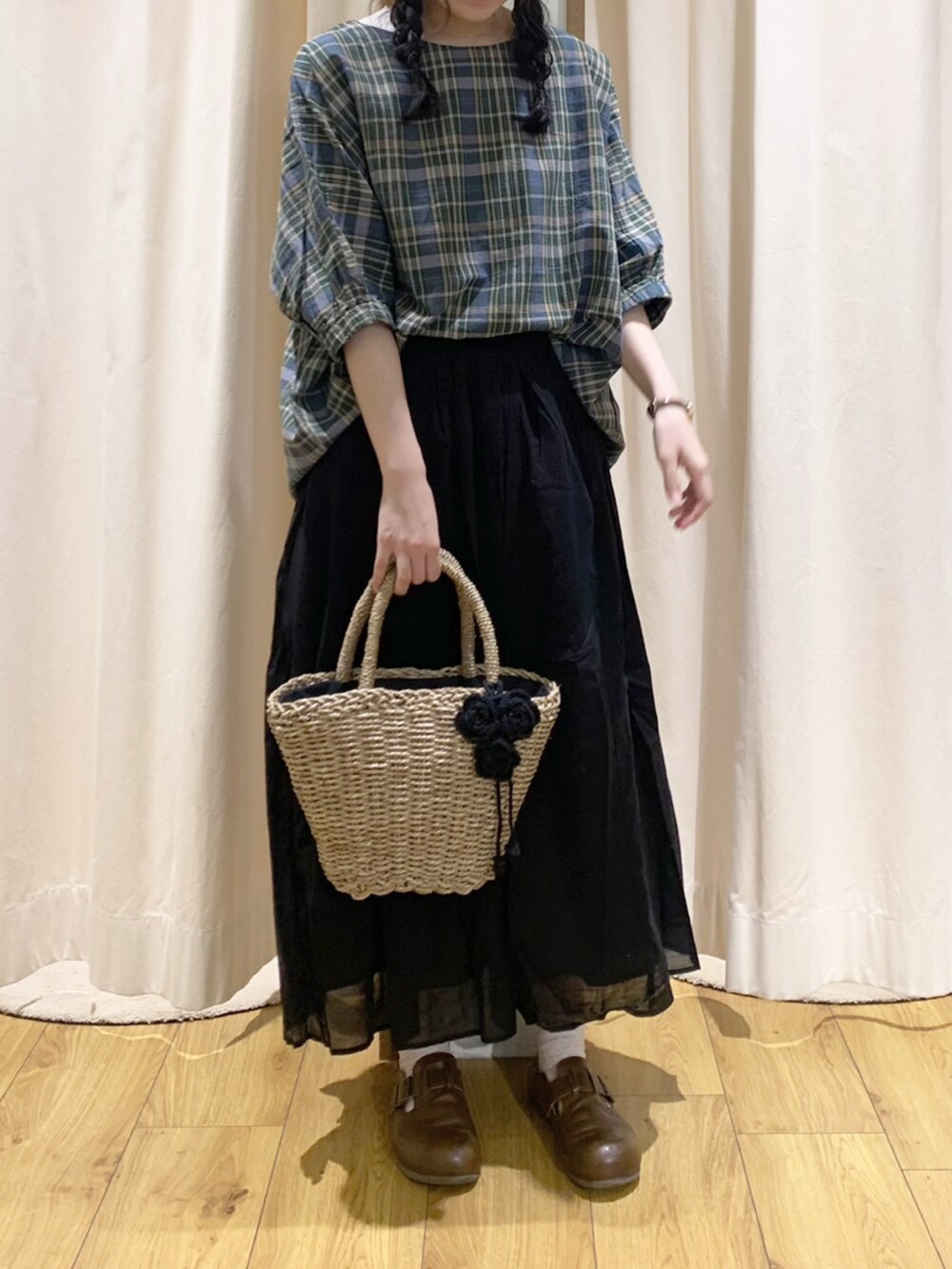 グリーン系のシャツ/ブラウス、ブラック系のスカート、ホワイト系のTシャツ/カットソーを着用したレディースの夏コーディネートの2枚目の写真