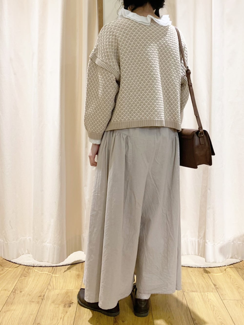 ベージュ系のニット/セーター、ホワイト系のシャツ/ブラウス、ベージュ系のその他パンツを着用したレディースの春コーディネートの4枚目の写真