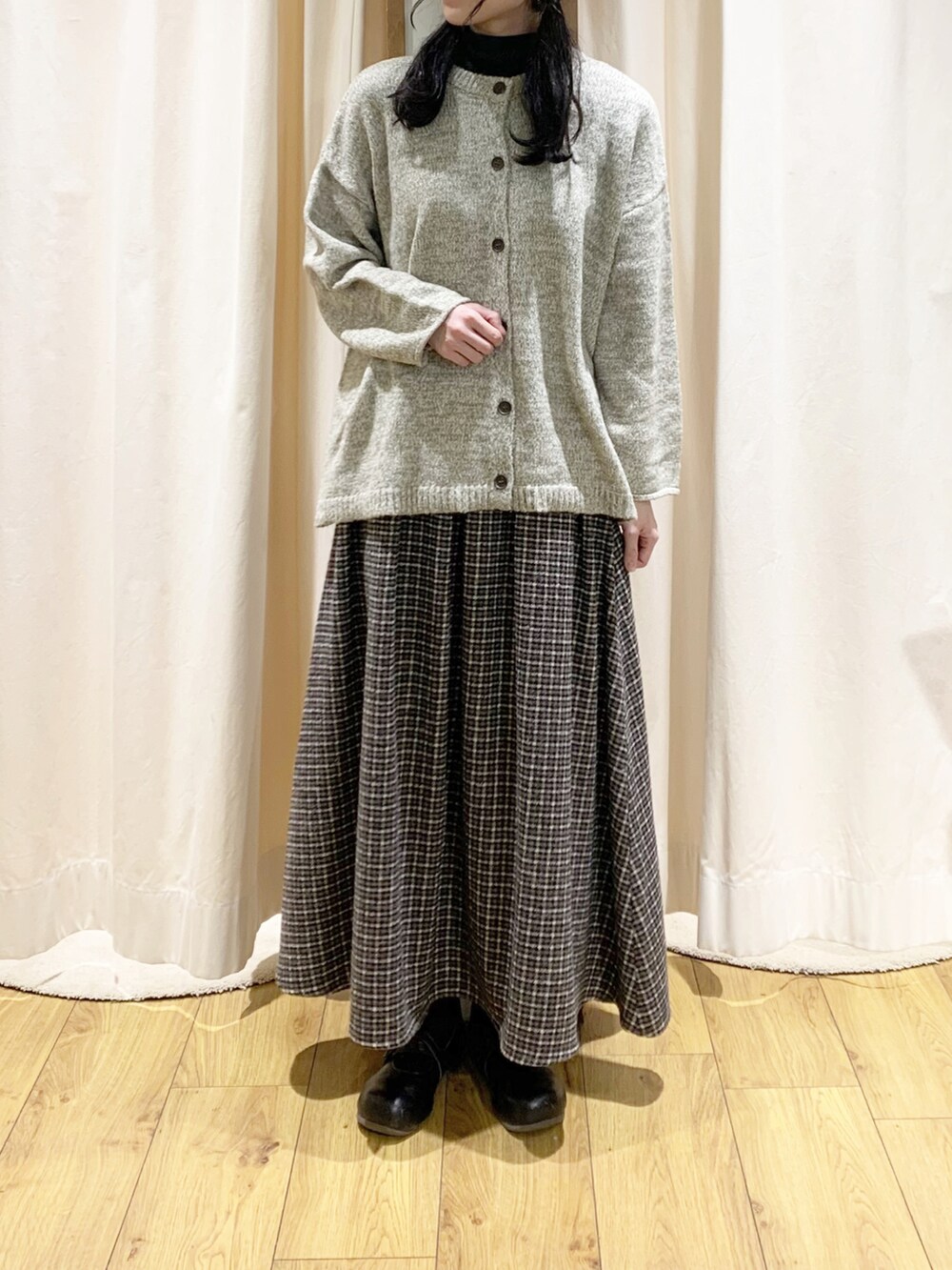 ベージュ系のブルゾン、グレー系のニット/セーター、ブラウン系のカーディガン/ボレロを着用したレディースの冬コーディネートの4枚目の写真