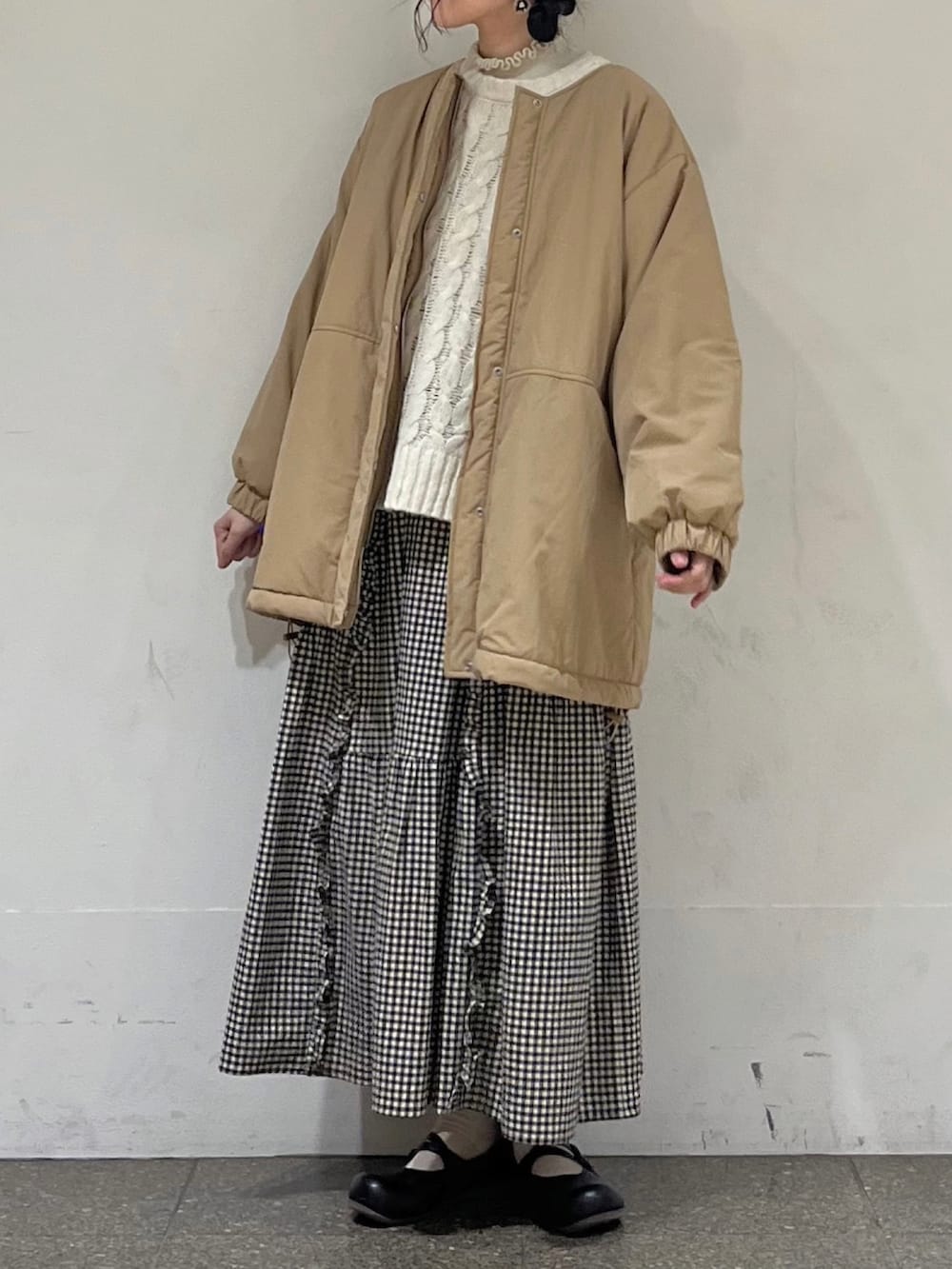 ホワイト系のニット/セーター、ホワイト系のカーディガン/ボレロ、ベージュ系のブルゾンを着用したレディースの冬コーディネートの2枚目の写真