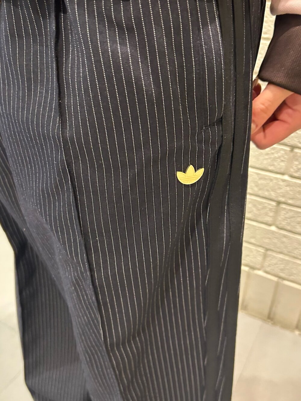 ピンク系のジャージ、ブラック系のスウェットパンツ、ブラウン系のスニーカーを着用したレディースの冬コーディネートの3枚目の写真