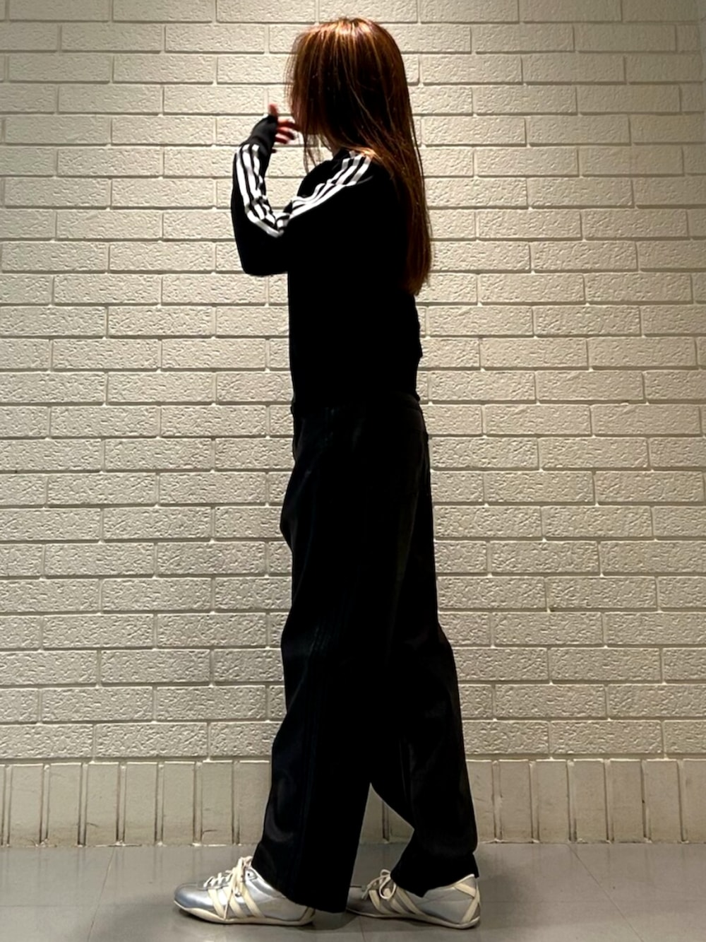 ブラック系のジャージ、シルバー系のスニーカー、ブラック系のその他パンツを着用したレディースの秋コーディネートの2枚目の写真