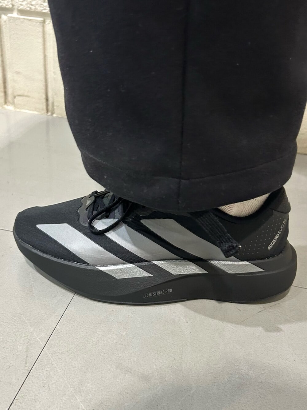 ブラック系のスニーカー、ピンク系のジャージを着用したレディースの冬コーディネートの2枚目の写真