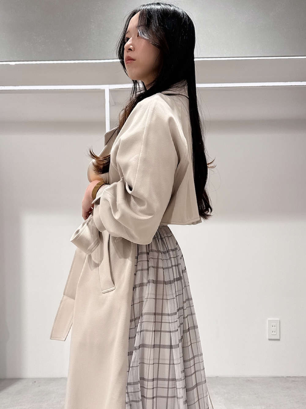 ベージュ系のトレンチコート、ブラウン系のハンドバッグ、ブラウン系のパンプスを着用したレディースの冬コーディネートの5枚目の写真