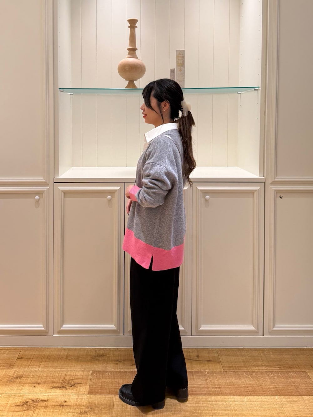 グレー系のカーディガン/ボレロ、ホワイト系のシャツ/ブラウス、ブラック系のその他パンツを着用したレディースの冬コーディネートの2枚目の写真