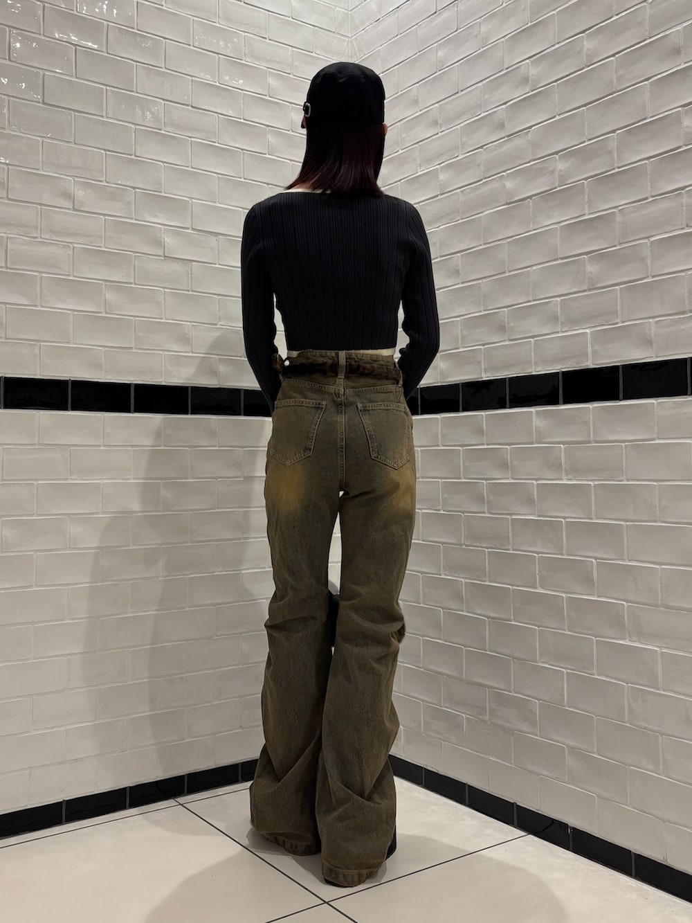 グレー系のニット/セーター、ベージュ系のデニムパンツ、ブラック系のスリッポンを着用したレディースの秋コーディネートの3枚目の写真
