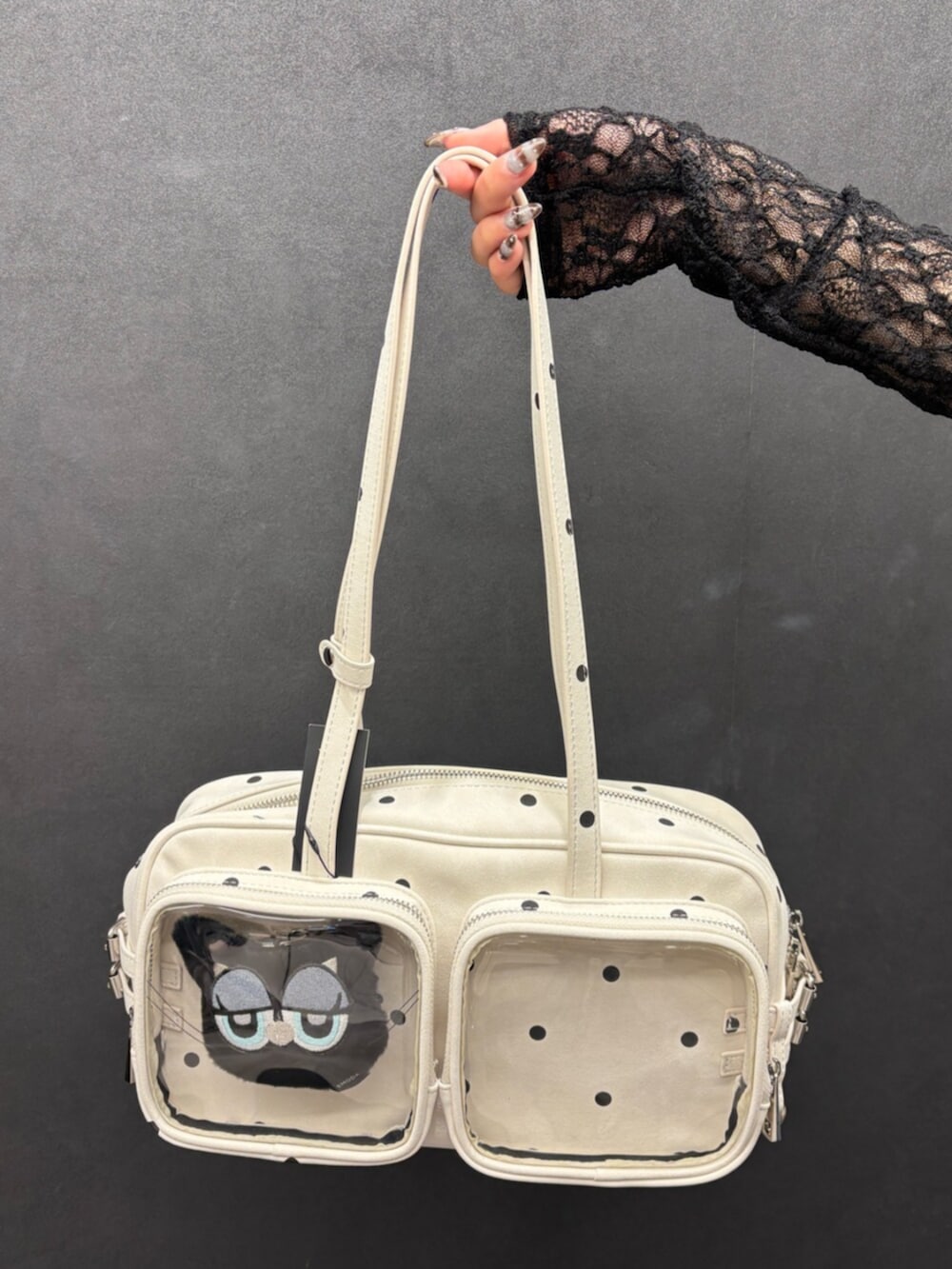 ブラウン系のハンドバッグ、ブラック系のサンダル、ブルー系のデニムパンツを着用したレディースの春コーディネートの5枚目の写真