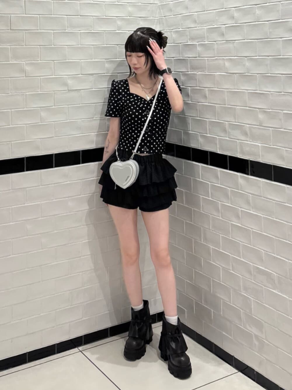ブラック系のブーツ、シルバー系のショルダーバッグ、その他のTシャツ/カットソーを着用したレディースの夏コーディネートの4枚目の写真