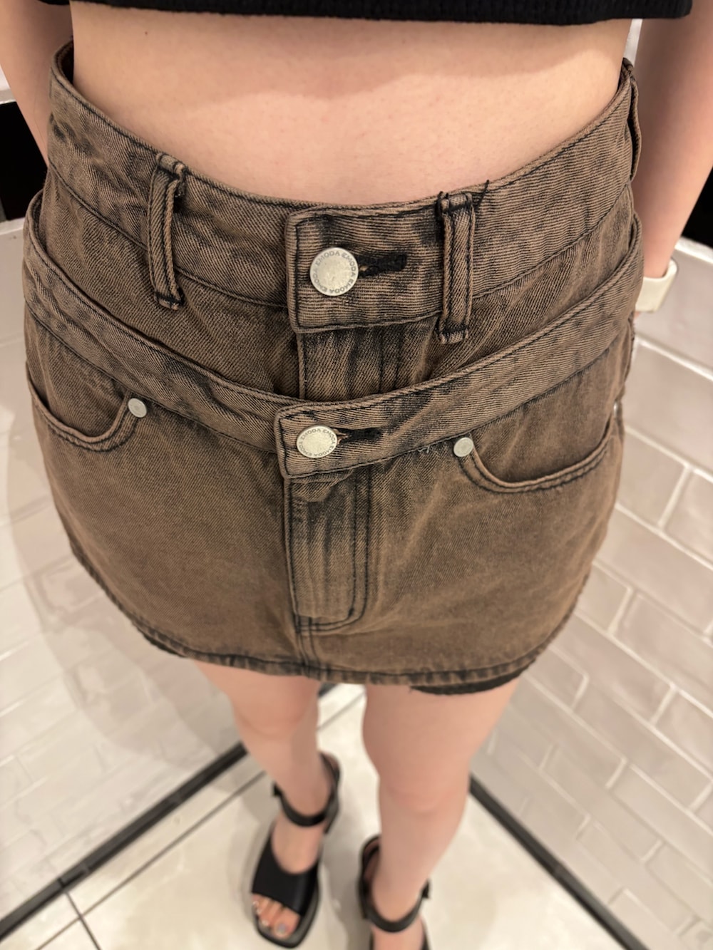 ブラック系のニット/セーター、ブラウン系のスカート、ブラック系のサンダルを着用したレディースの春コーディネートの6枚目の写真