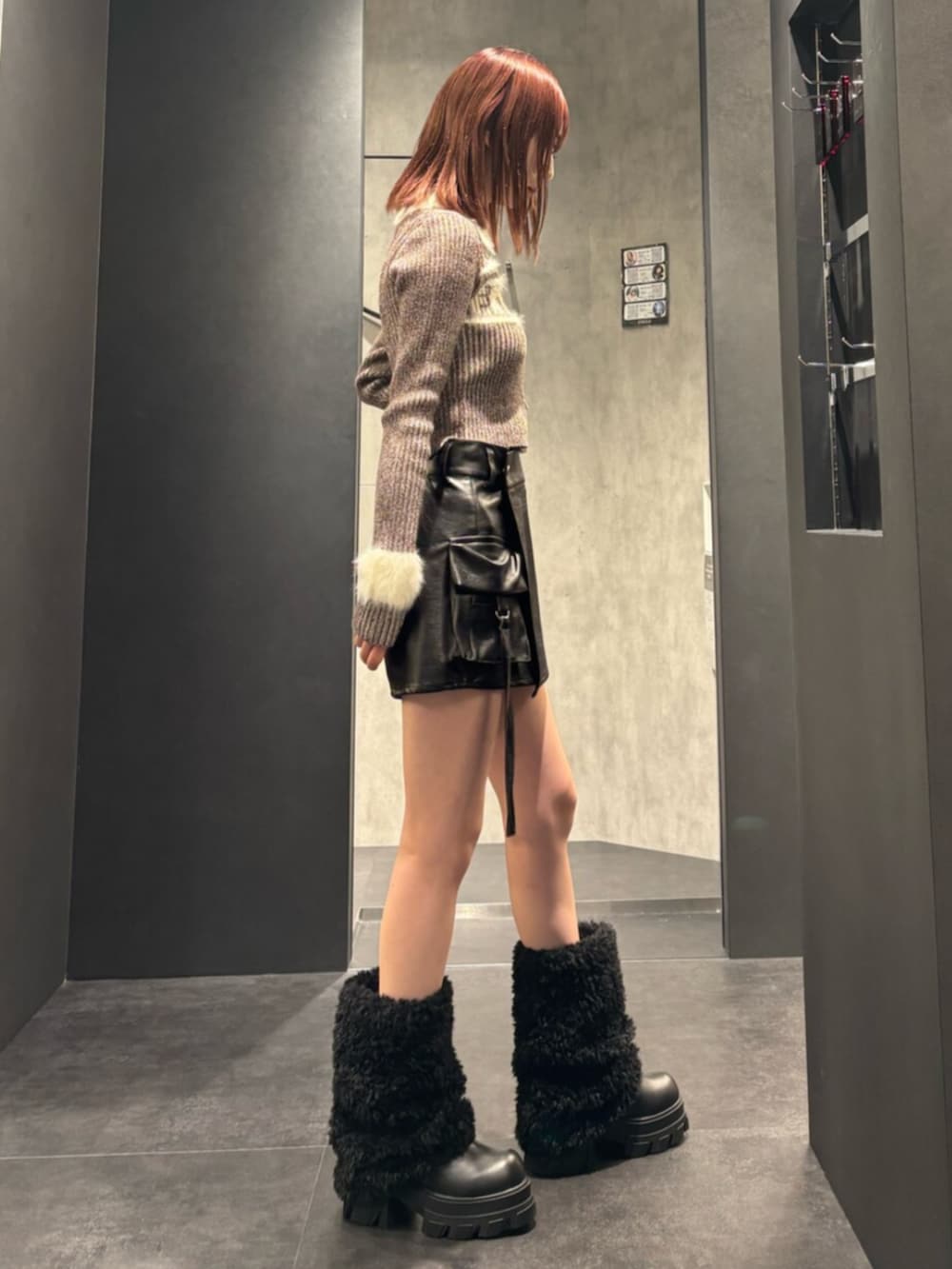 ブラウン系のニット/セーター、ブラック系のその他パンツ、ブラック系のブーツを着用したレディースの冬コーディネートの2枚目の写真