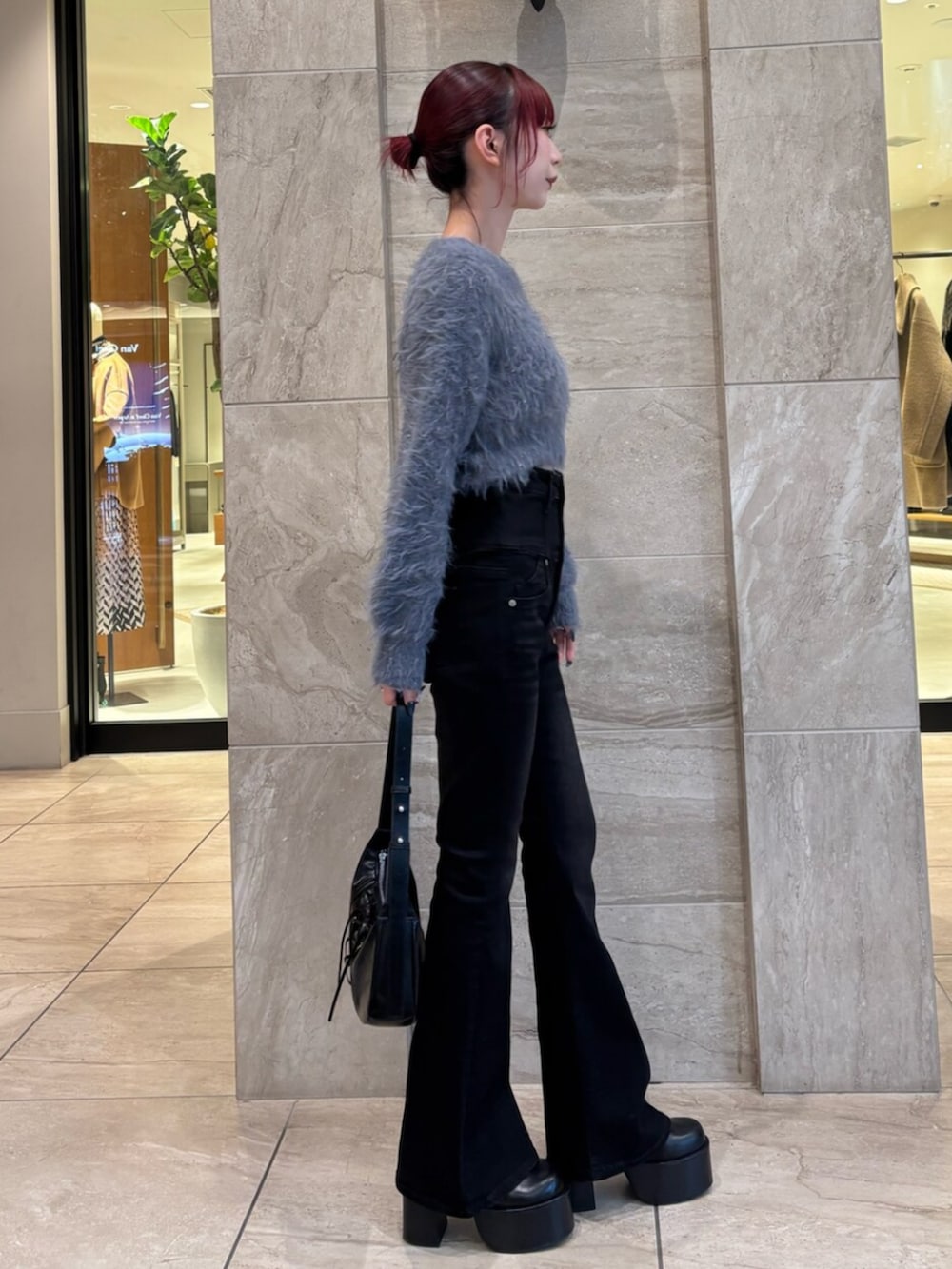 ブラック系のブーツ、グレー系のニット/セーター、ブラック系のデニムパンツを着用したレディースの冬コーディネートの3枚目の写真