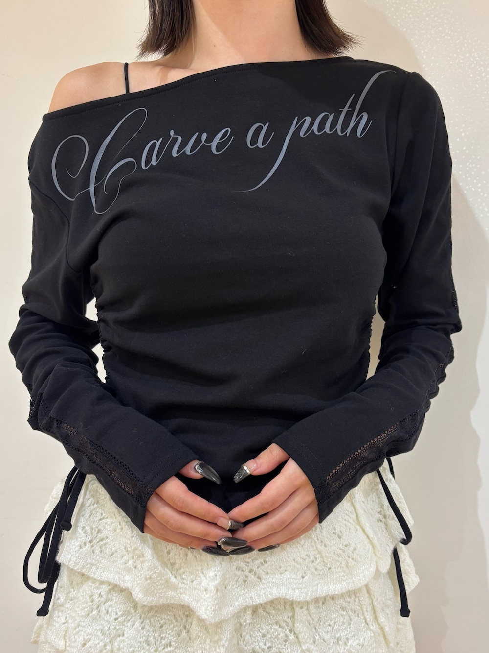 ブラック系のTシャツ/カットソー、ホワイト系のスカート、ベージュ系のブーツを着用したレディースの夏コーディネートの4枚目の写真