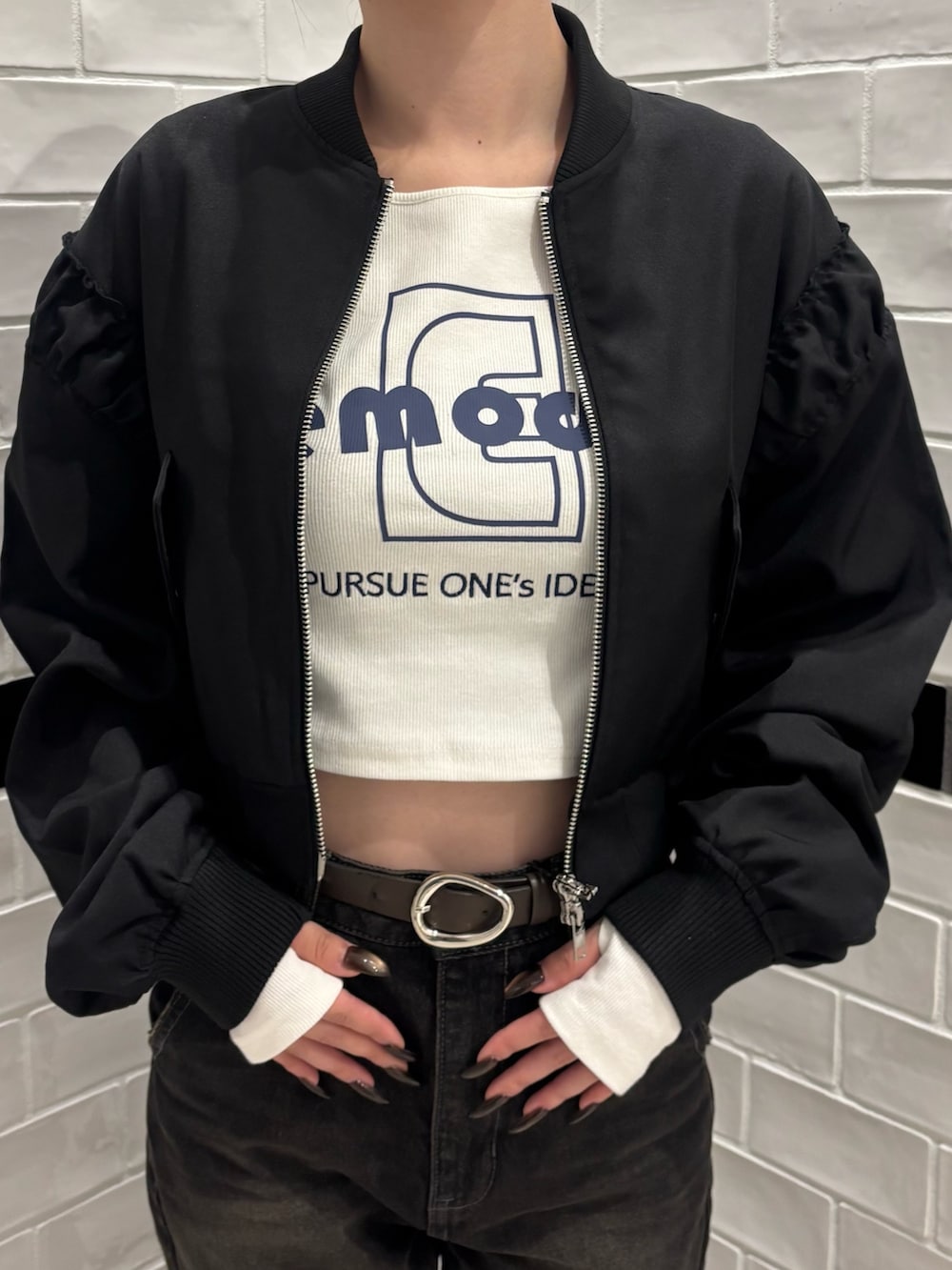 ブラック系のデニムパンツ、ブラック系のスリッポン、ブラック系のブルゾンを着用したレディースの秋コーディネートの4枚目の写真