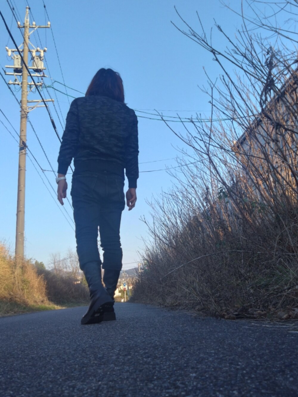 ブラック系のデニムパンツ、ブラック系のブルゾン、ブラック系のブーツを着用したメンズの春コーディネートの2枚目の写真