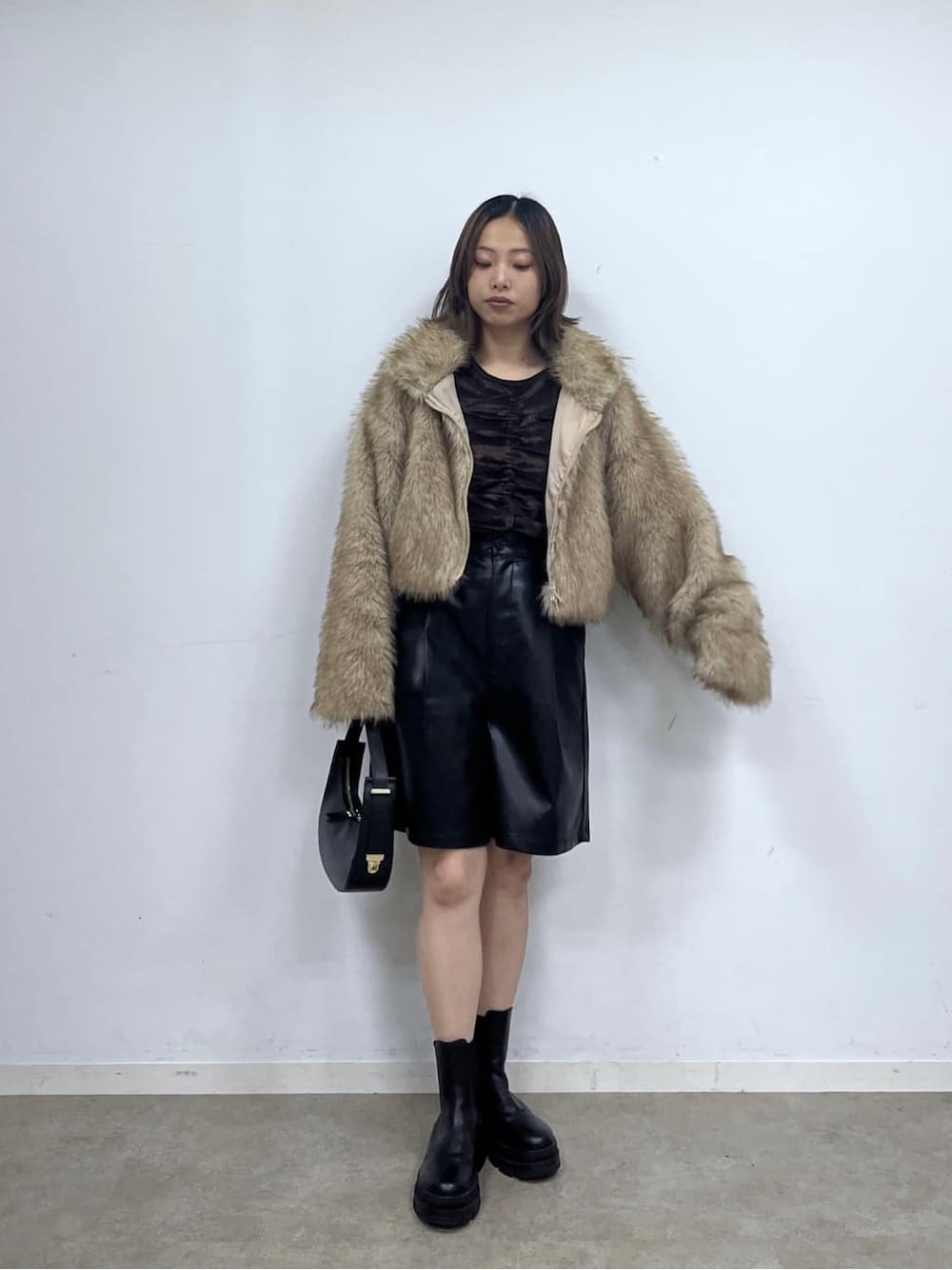 イエロー系のブルゾン、ブラック系のその他パンツ、ブラック系のショルダーバッグを着用したレディースの秋コーディネートの2枚目の写真