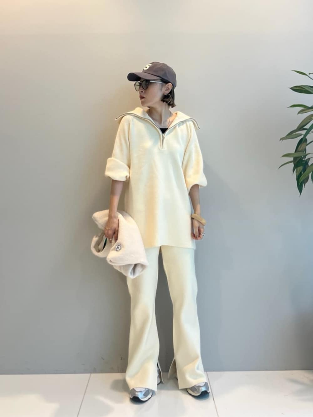 ホワイト系のその他パンツ、ホワイト系のニット/セーター、ホワイト系のトートバッグを着用したレディースの冬コーディネートの3枚目の写真