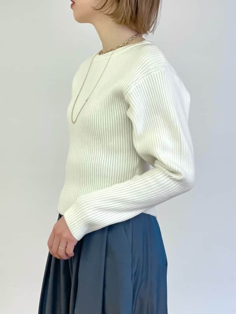 ホワイト系のニット/セーター、ブルー系のスカートを着用したレディースの冬コーディネートの3枚目の写真