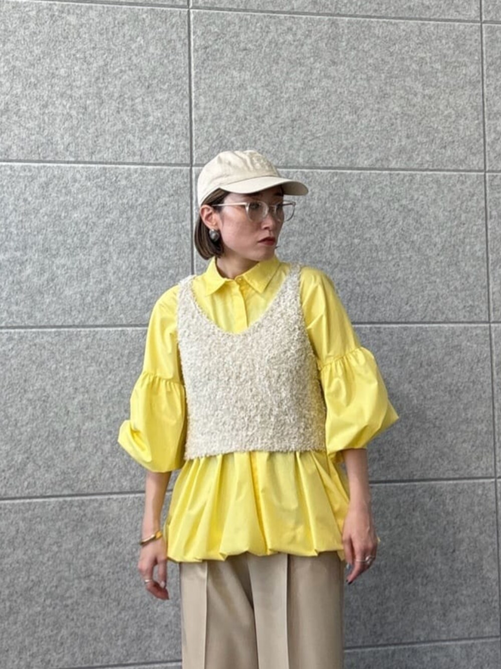 ベージュ系のその他パンツ、ホワイト系のベスト、イエロー系のシャツ/ブラウスを着用したレディースの春コーディネートの5枚目の写真