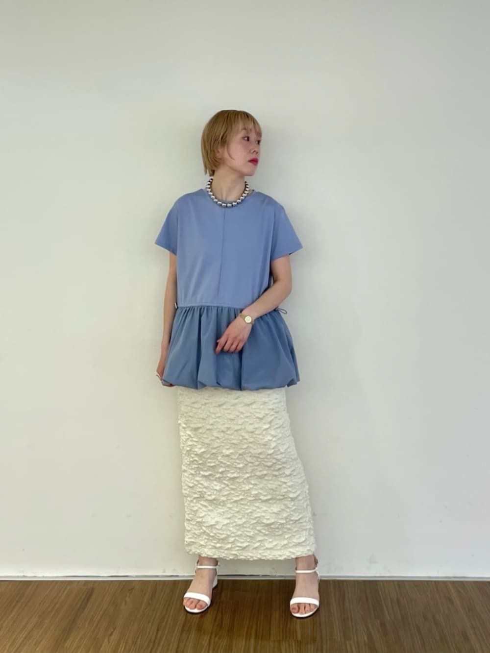 ホワイト系のスカート、ブルー系のTシャツ/カットソー、シルバー系のネックレスを着用したレディースの春コーディネートの2枚目の写真