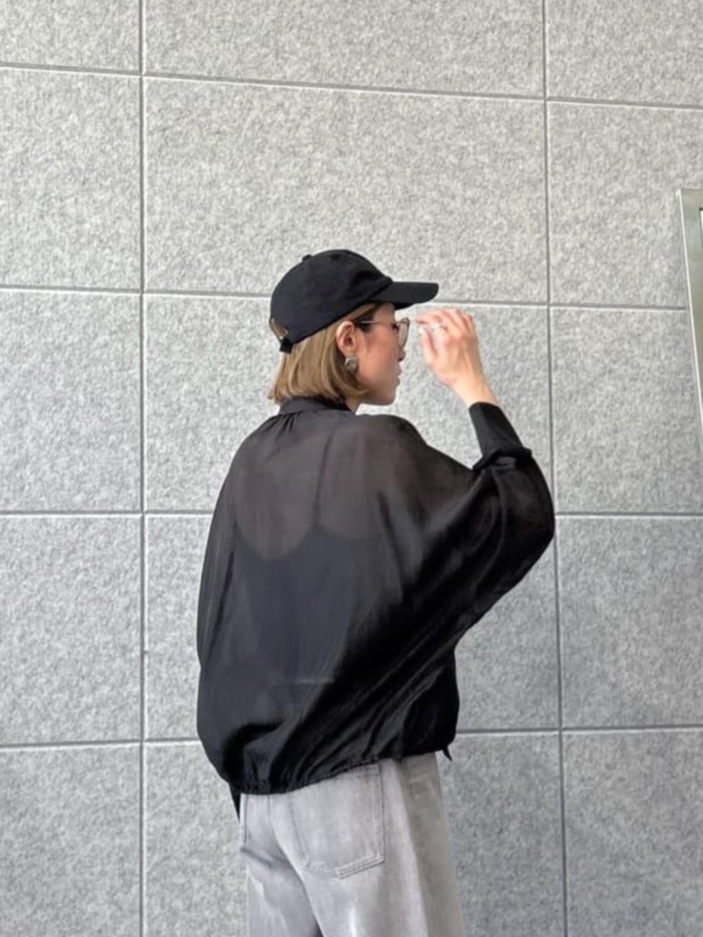 グレー系のデニムパンツ、ブラック系のシャツ/ブラウスを着用したレディースの春コーディネートの4枚目の写真