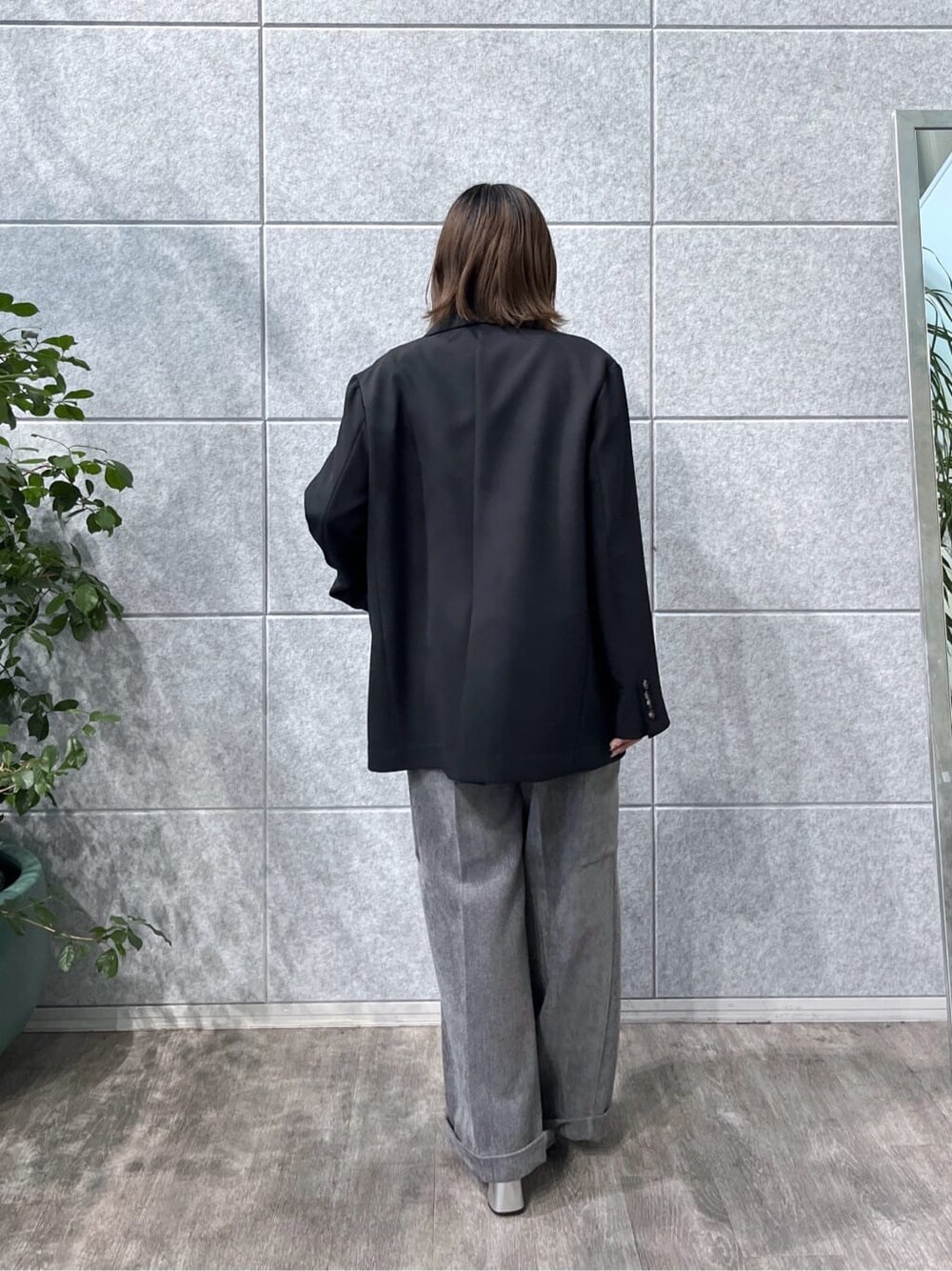 ブラック系のテーラードジャケット、グレー系のニット/セーター、グレー系のその他パンツを着用したレディースの秋コーディネートの4枚目の写真