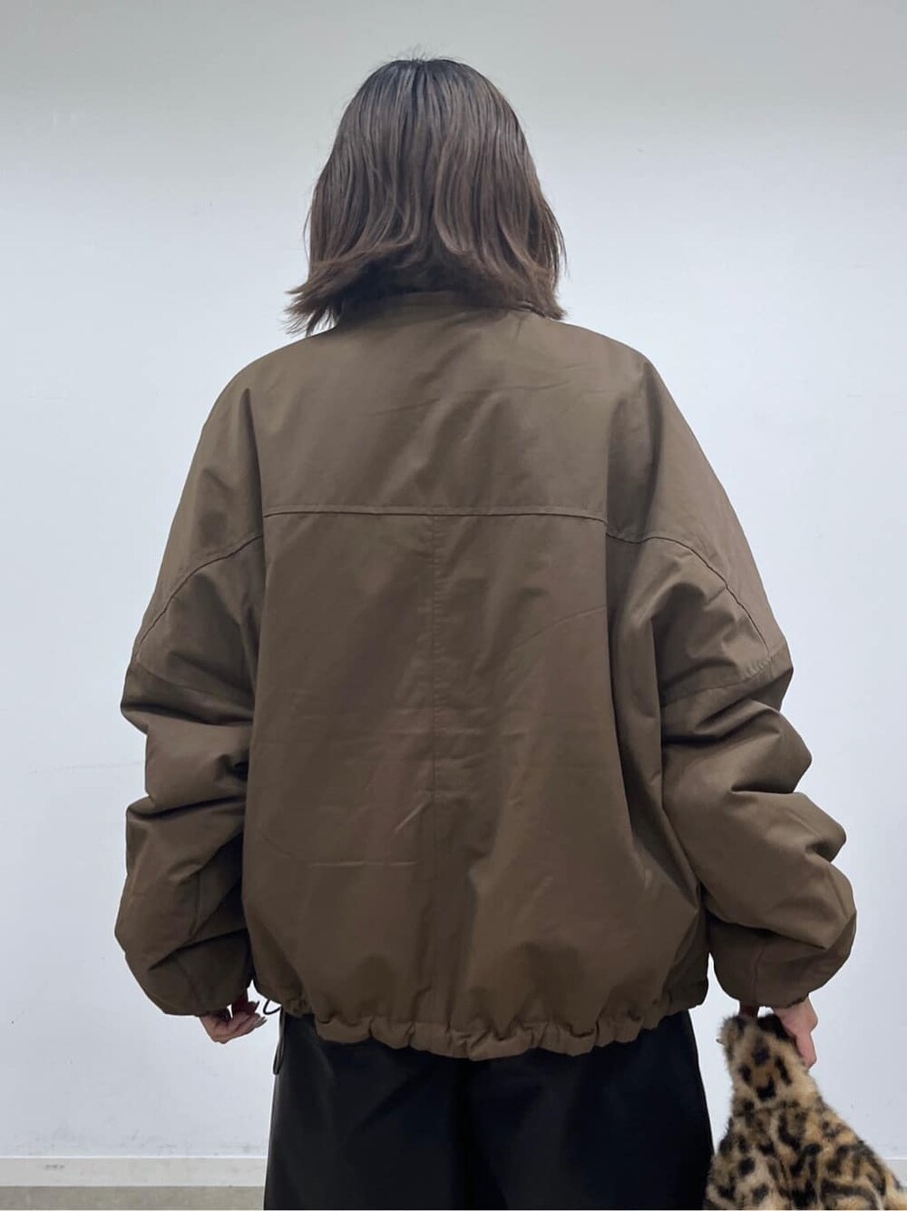 ブラウン系のその他アウター、ブラック系のその他パンツ、ブラウン系のハンドバッグを着用したレディースの秋コーディネートの7枚目の写真