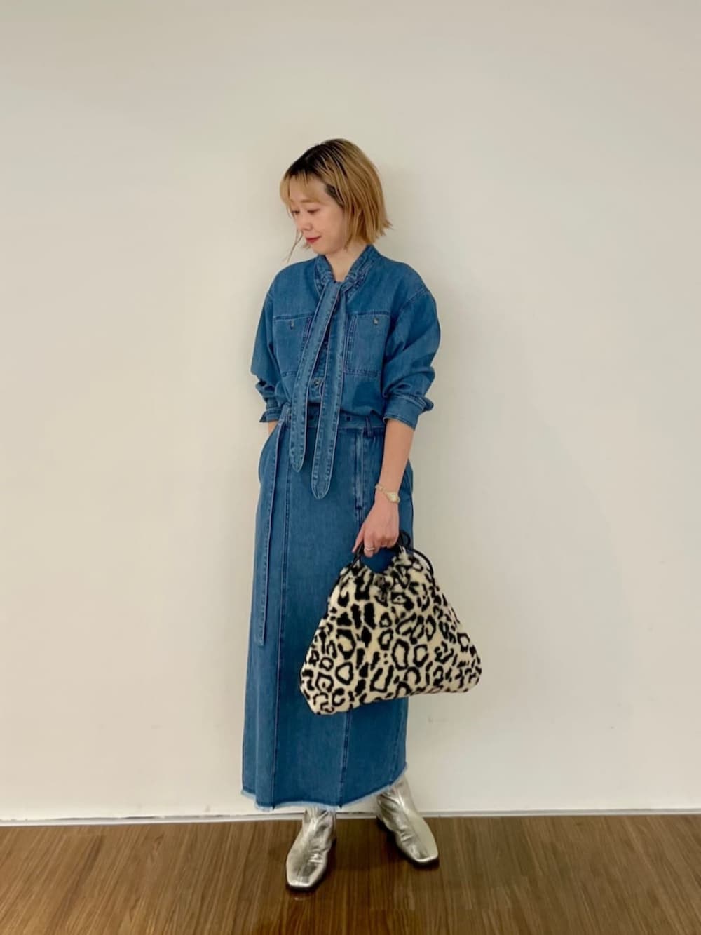 ブルー系のシャツ/ブラウス、ブルー系のデニムスカート、ブラウン系のハンドバッグを着用したレディースの秋コーディネートの3枚目の写真