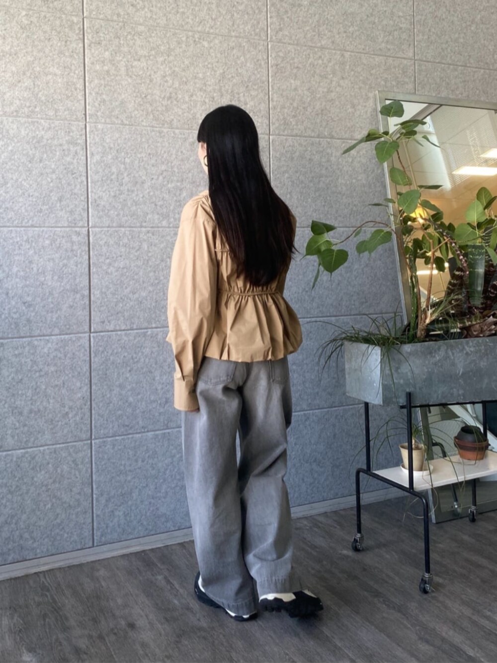 グレー系のデニムパンツ、ベージュ系のシャツ/ブラウスを着用したレディースの春コーディネートの3枚目の写真