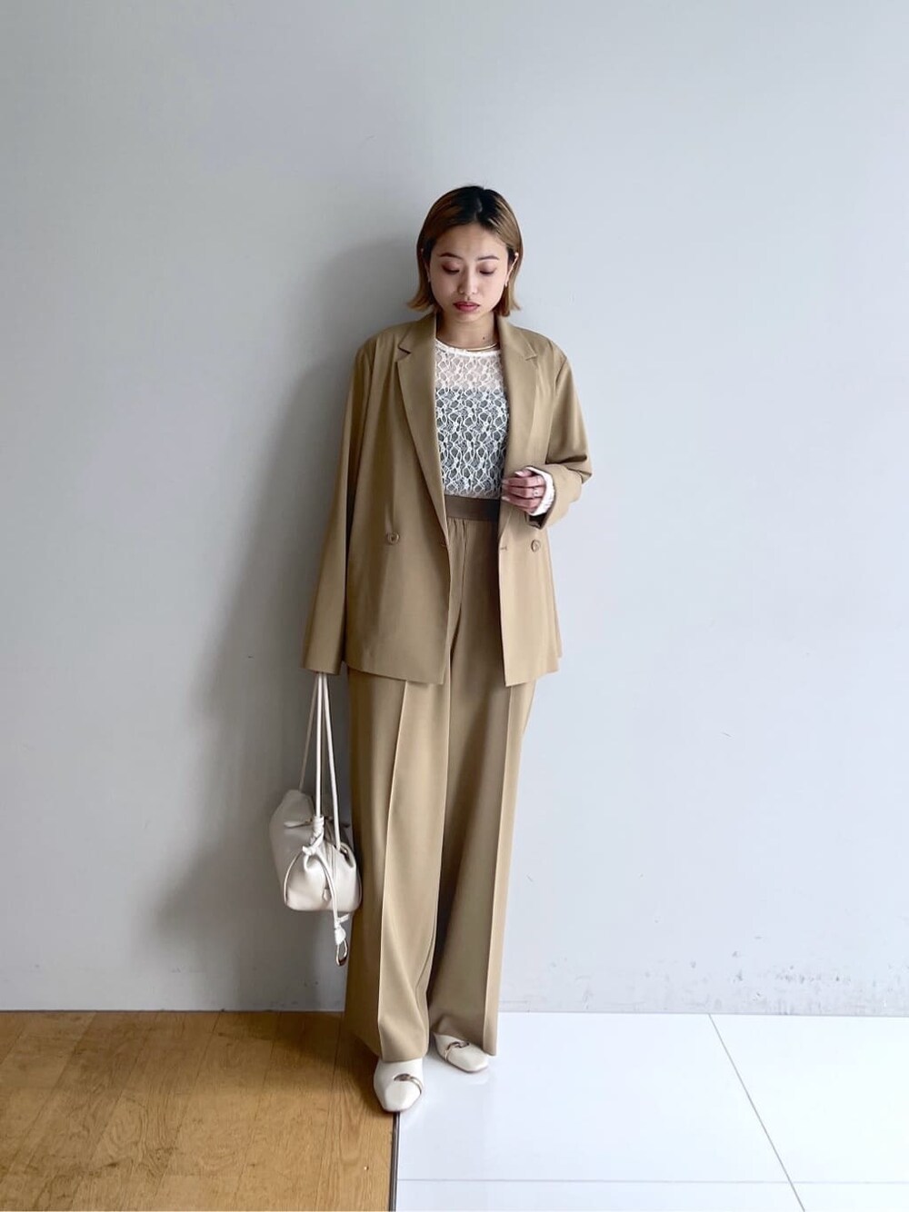 イエロー系のテーラードジャケット、ホワイト系のTシャツ/カットソー、イエロー系のその他パンツを着用したレディースの春コーディネートの8枚目の写真